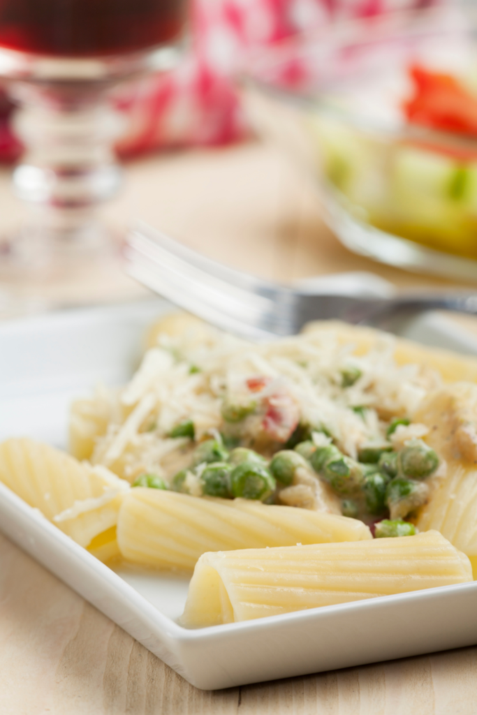 peas and pasta on a white plate